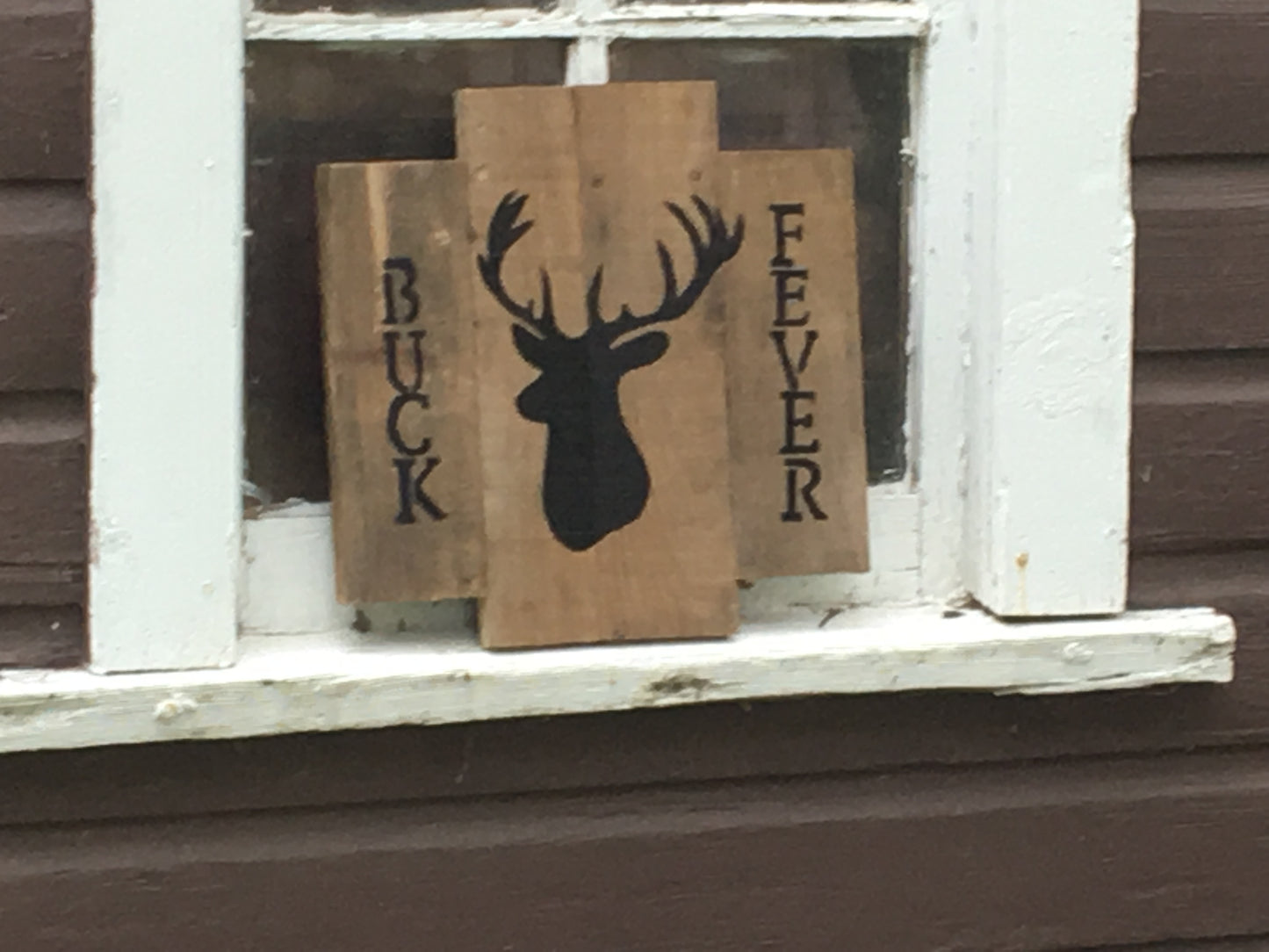 Buck Fever Pallet sign in window of barn