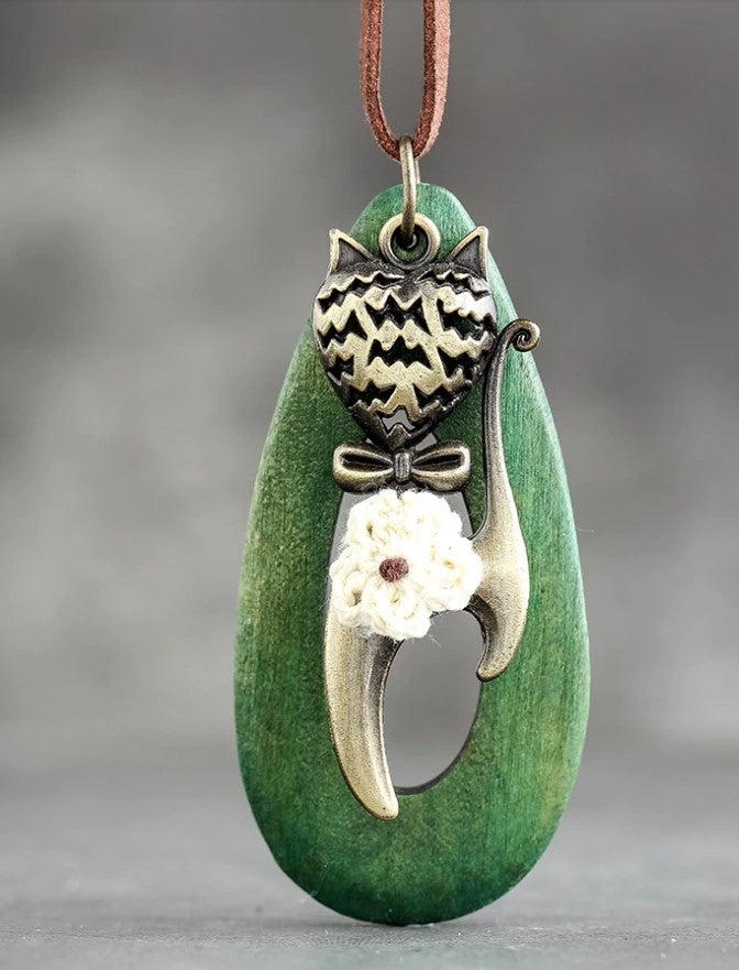 green meow necklace hanging