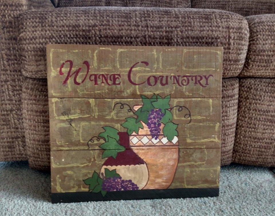 wine country wood sign in front of chair