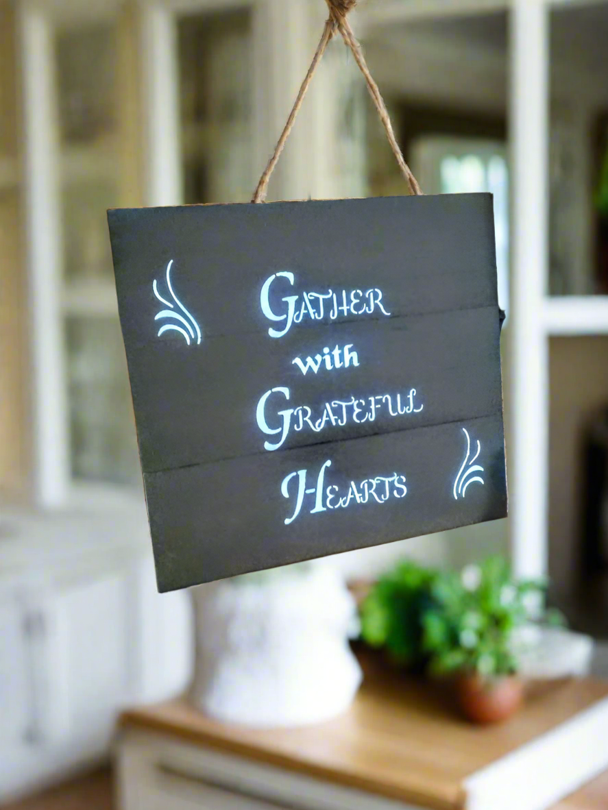 handmade wooden sign saying to gather with grateful hearts
