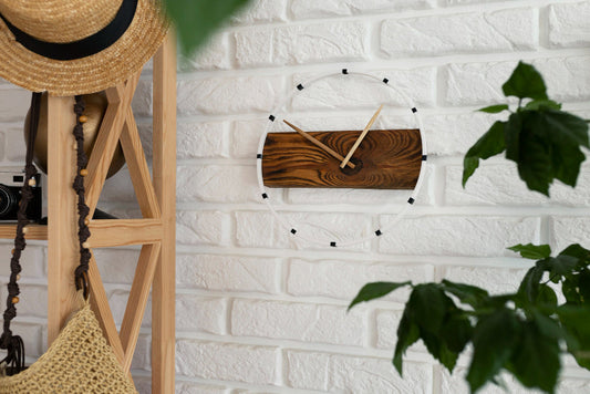 wooden clock on white brick wall