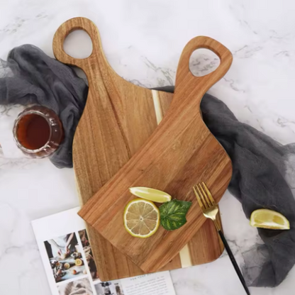 Wooden cutting board with lemon slices and a fork on a marble surface
