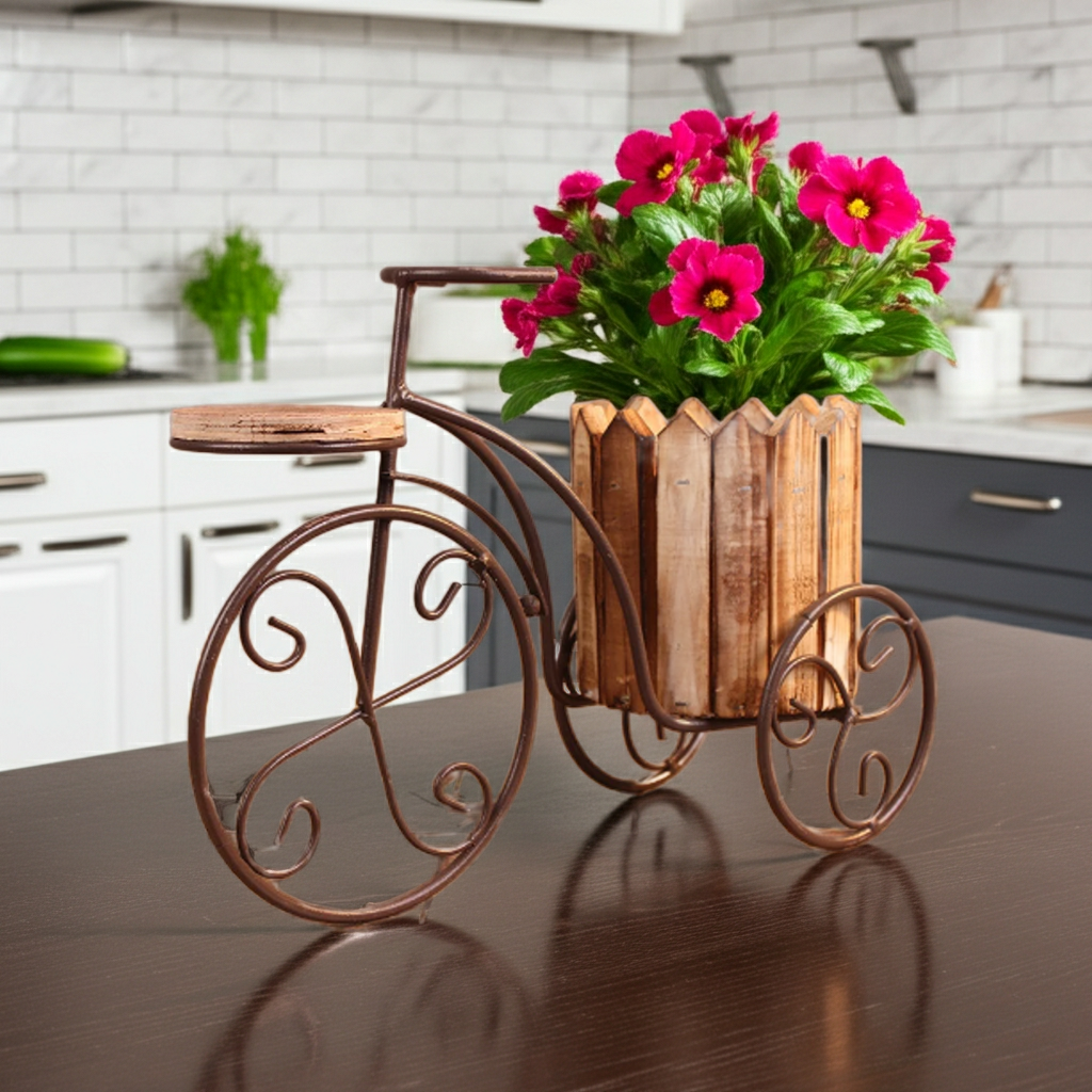 Decorative bicycle planter with pink flowers on a kitchen counter