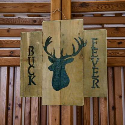 Wooden sign with deer silhouette and 'Buck Fever' text against a wooden background