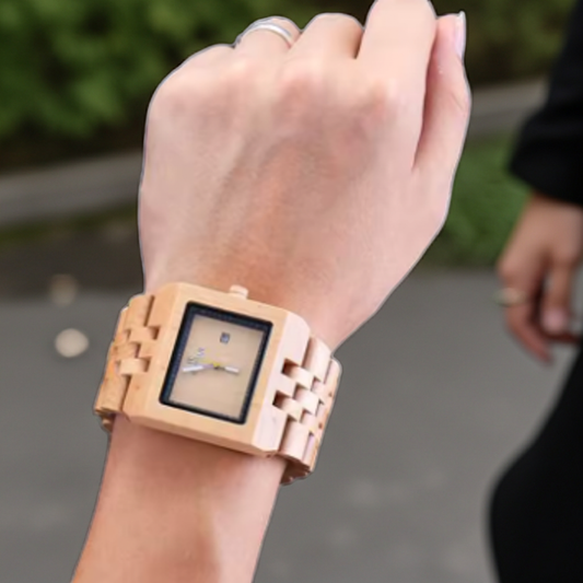Wooden wristwatch on a person's wrist with a blurred background