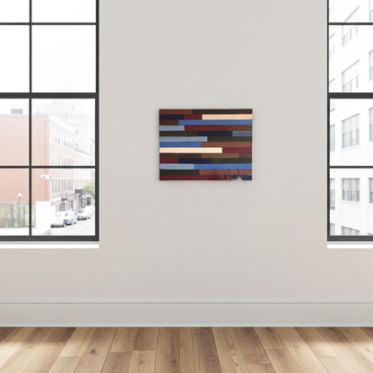 Abstract multicolored painting on a white wall with large windows.