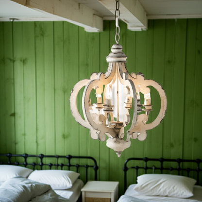 Vintage-style chandelier hanging in a room with green paneled walls and two beds.