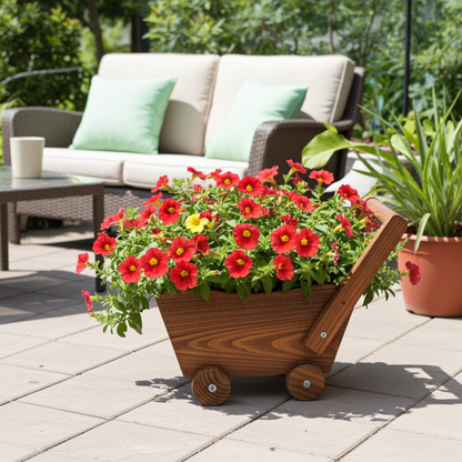 Wooden cart planter with red flowers on a patio with outdoor furniture in the background