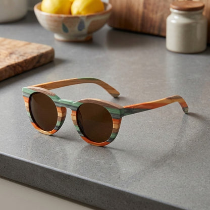 color filled wood frame sunglasses siting on kitchen counter