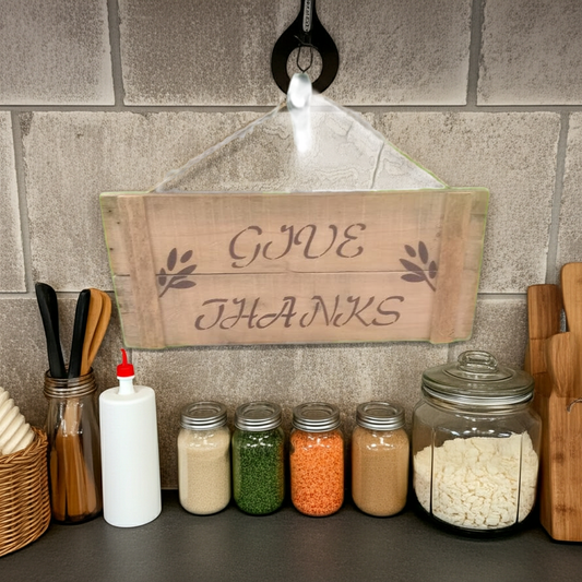 Spice jars with a 'Give Thanks' sign on a stone wall background