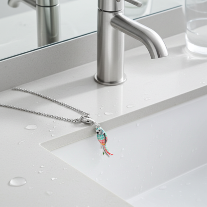 Silver necklace with a colorful pendant on a bathroom counter