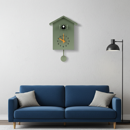 Blue sofa with gray cushions in a room with a green wall clock.