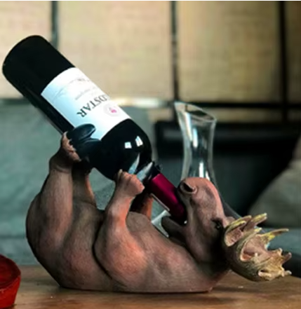 Novelty animal-shaped wine bottle holder on a table