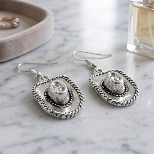 cowboy hat earrings closeup