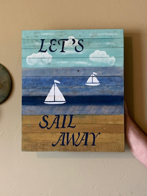 Sail Away sign on beige wall