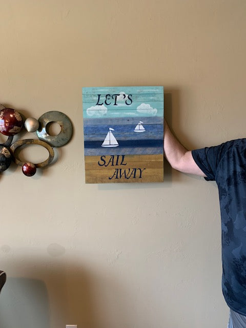 Sail Away sign being held on wall
