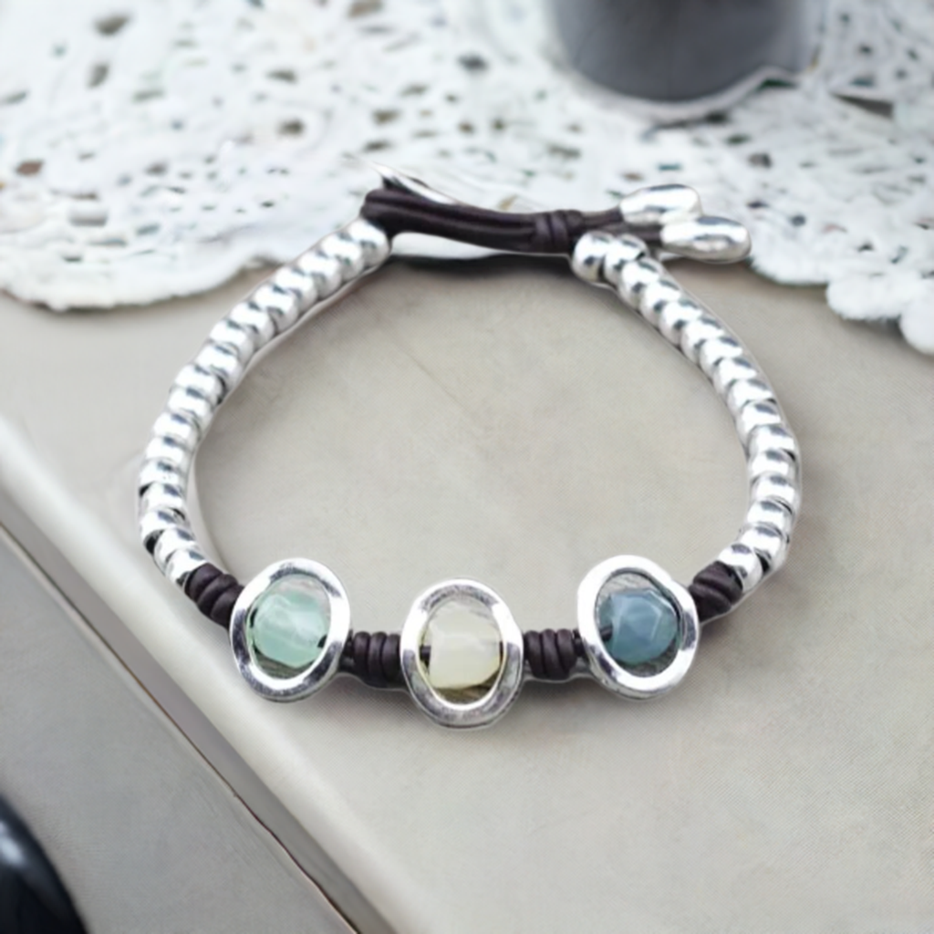 silver bead bracelet next to doily
