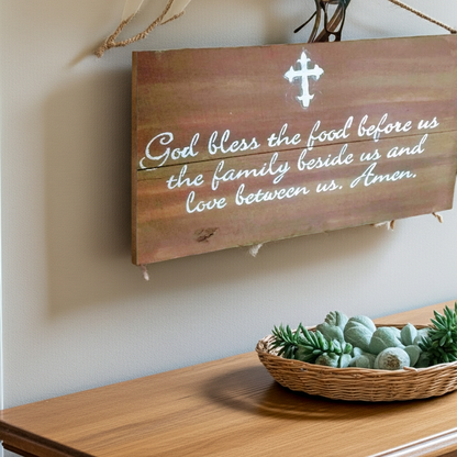 Wooden sign with a prayer on a wall above a wooden surface with a basket of succulents.