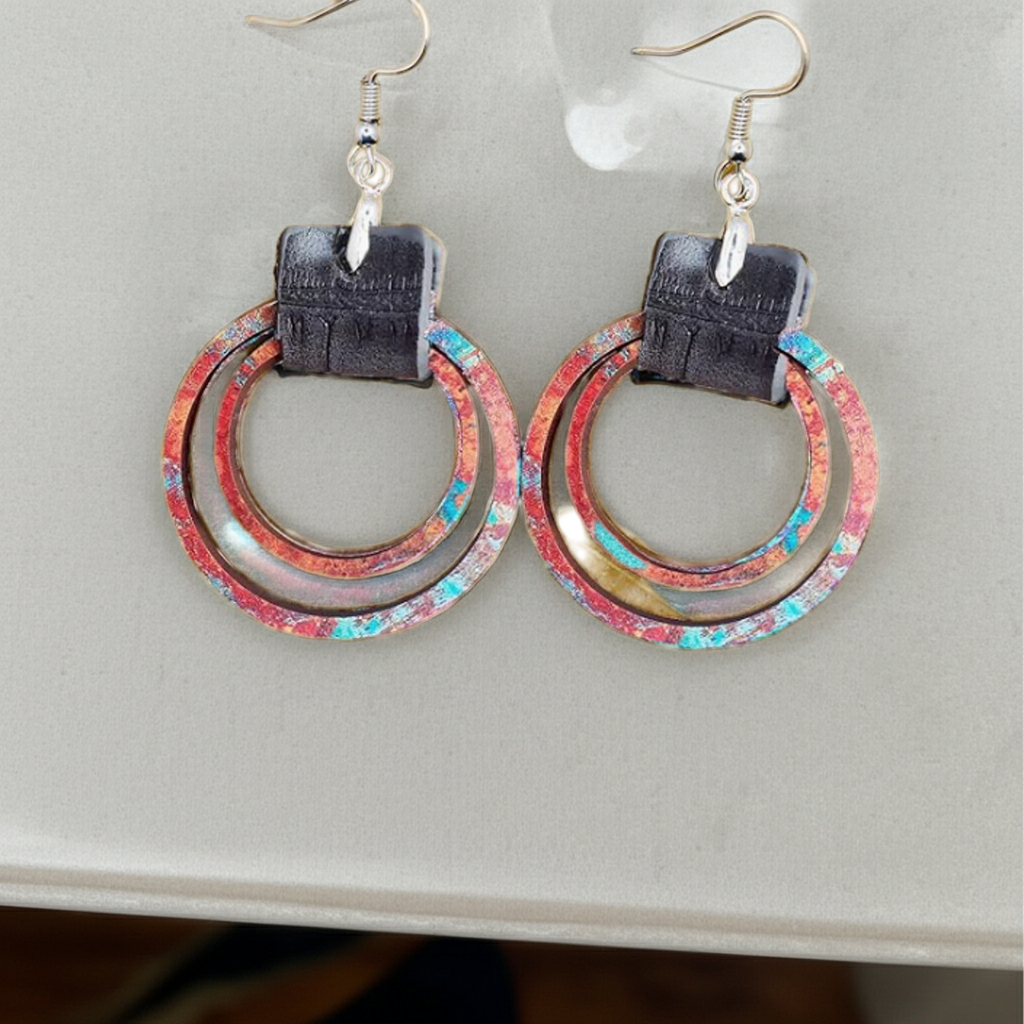 Colorful hoop earrings on a light gray surface