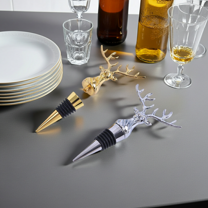 Two deer-shaped bottle stoppers on a table with glasses and bottles in the background.