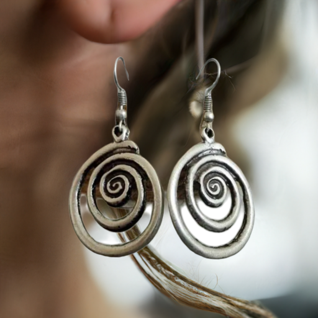swirly earrings on woman