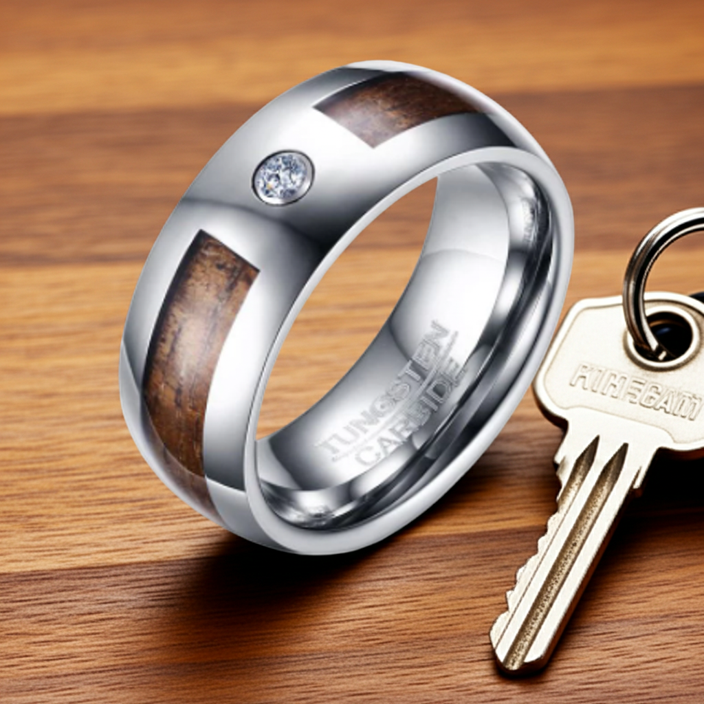 Silver ring with wooden inlay and diamond next to a key on a wooden surface