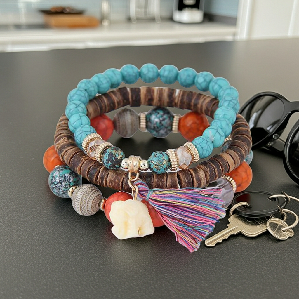 Colorful beaded bracelets with a tassel on a dark surface, with keys and sunglasses in the background.