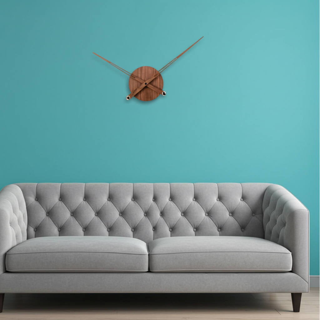 Gray tufted sofa against a teal wall with a wooden wall clock.