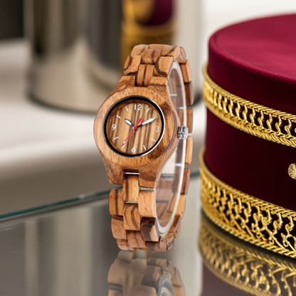Wooden watch with a decorative box on a reflective surface