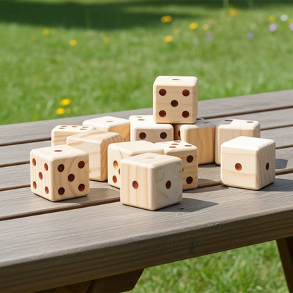 Wooden dice on a wooden table with a grassy background
