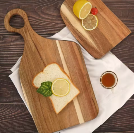 Wooden cutting board with slices of bread, lemon, and a small bowl of honey on a wooden surface.