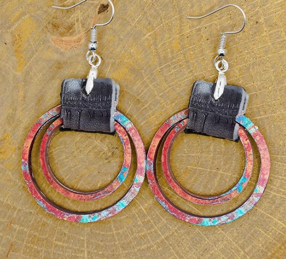 Pair of earrings with circular design on a textured surface