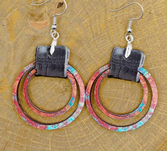 Pair of earrings with circular design on a textured surface