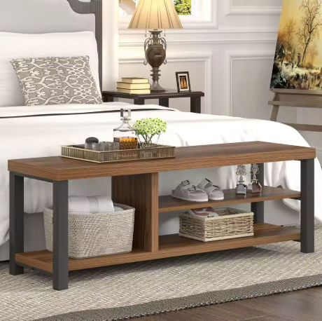 Wooden bench in a bedroom with a bed, nightstands, and decor items.