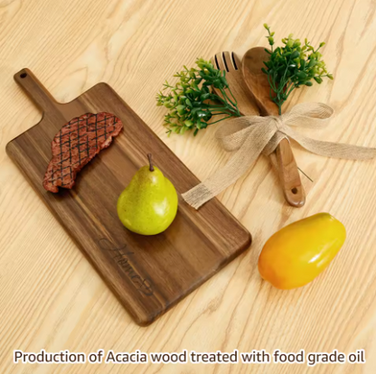 Wooden cutting board with a pear, a yellow fruit, and wooden utensils on a light wood background.