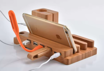 Wooden charging station with phone holder, USB ports, and cable management on a white background