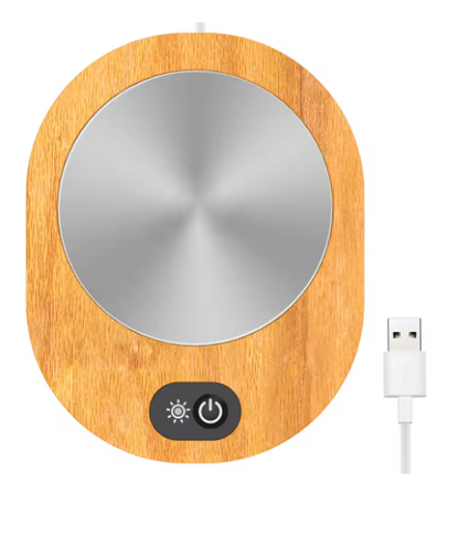 Wooden coaster with metal center and USB cable on a white background