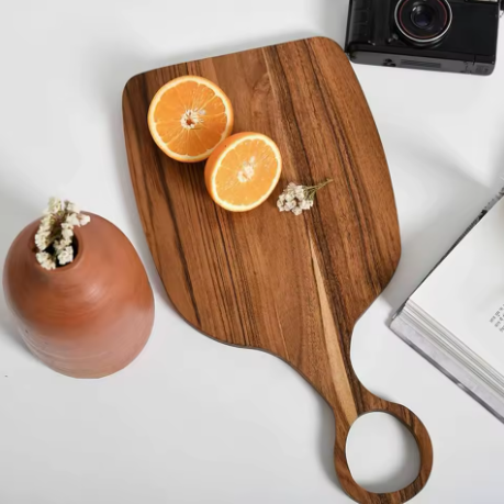 Wooden cutting board with sliced oranges on a white surface