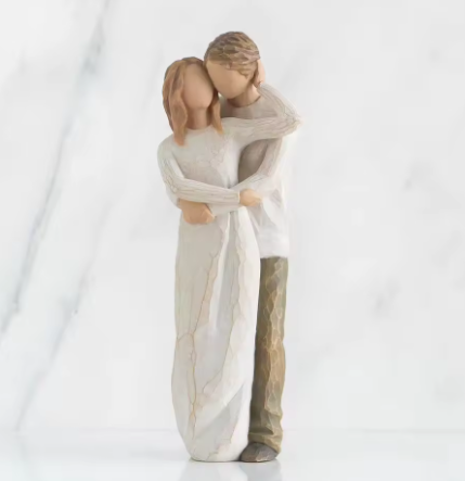 Statue of a couple embracing on a white background