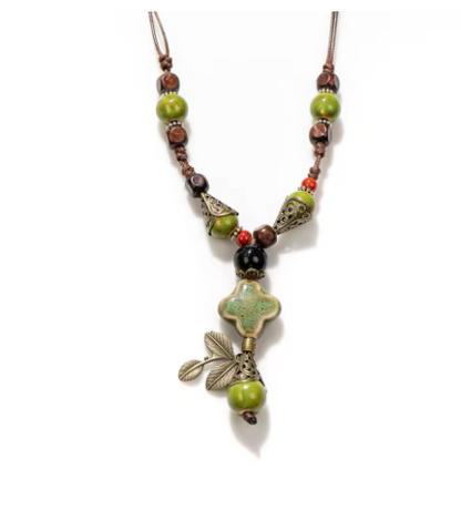 Necklace with green and brown beads on a white background