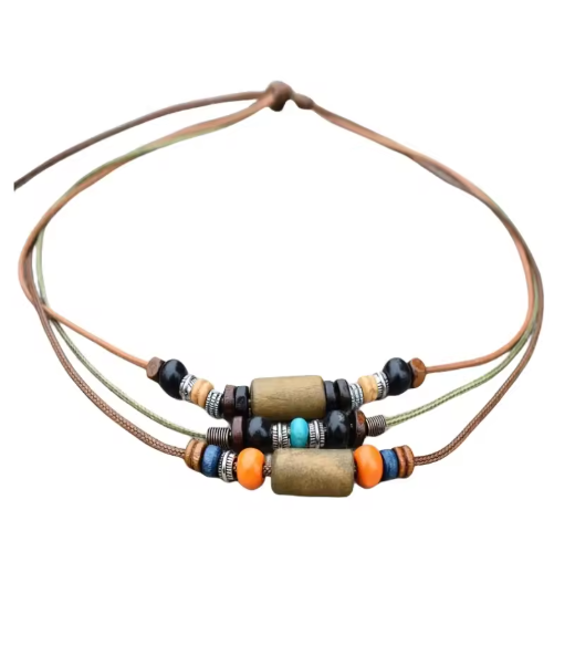 A multi-strand cord bracelet featuring natural wood cylindrical beads, small black beads, and accent beads in orange, turquoise, and silver, shown on a plain white background.