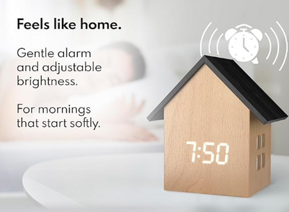 House-shaped digital clock with adjustable brightness and alarm feature on a white background
