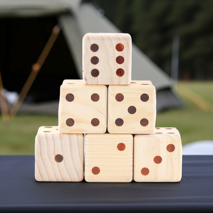 Stack of wooden dice with brown dots on a table outdoors