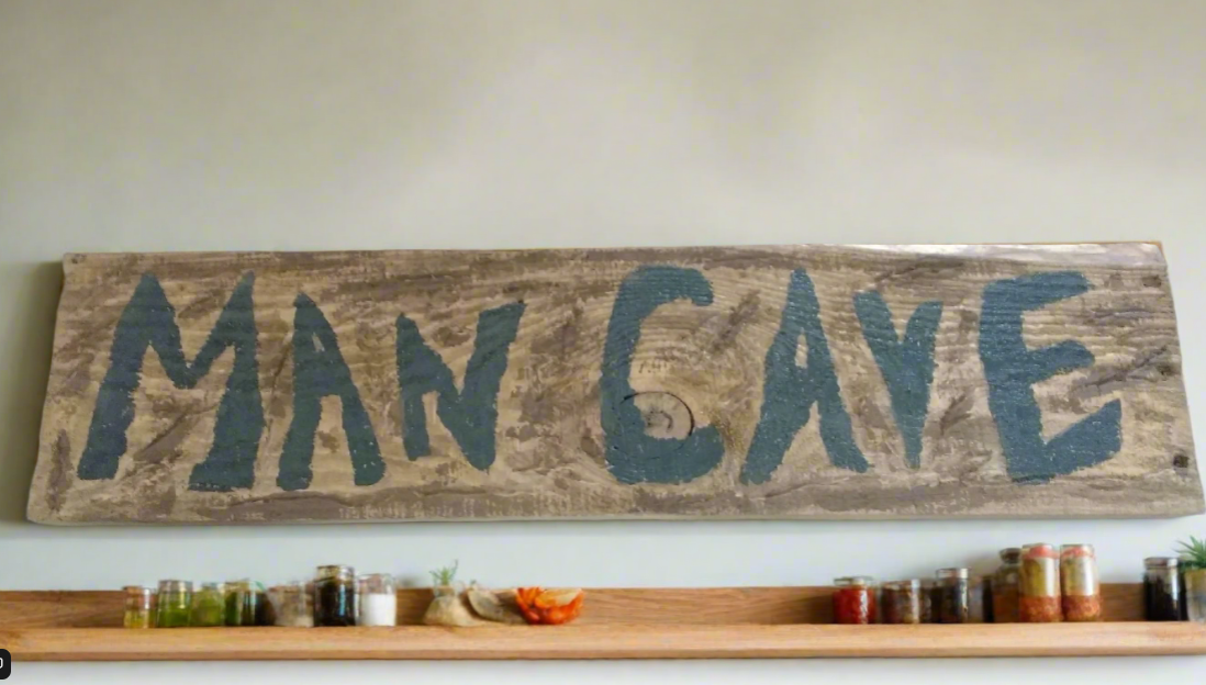 man cave sign hanging over mantle