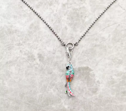 Necklace with a colorful pendant on a light gray background