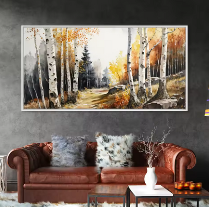 Painting of birch trees in an autumn landscape hanging above a brown leather sofa.