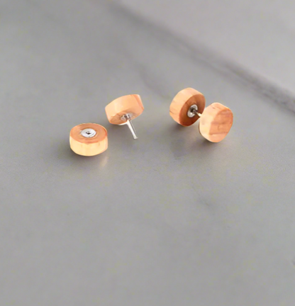 Wooden stud earrings on a gray surface