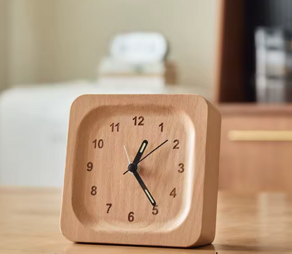 Wooden clock on a table with a blurred background