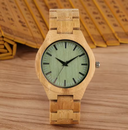 Wooden watch with a green face on a wooden surface