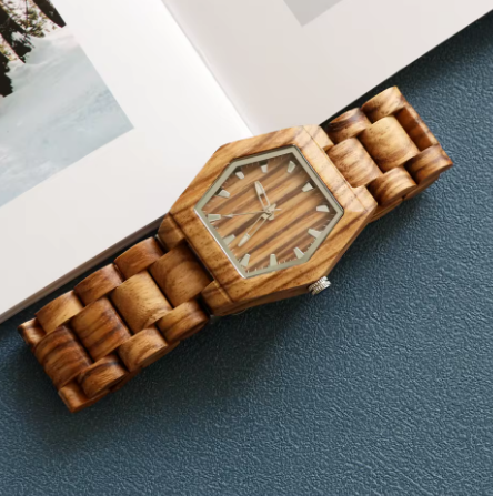 Wooden wristwatch with a hexagonal wooden strap on a dark surface